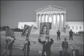  ?? SAMUEL CORUM/GETTY IMAGES ?? Supporters of Justice Amy Coney Barrett demonstrat­e in front of the Supreme Court of the United States on Monday in Washington, D.C.