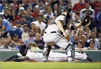  ?? AP photo ?? The Red Sox’s Jackie Bradley Jr. slides safely into home plate in front of Orioles catcher Andrew Susac as Boston defeated the Orioles 6-2 on Thursday.