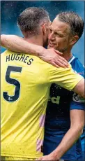  ??  ?? RESPECT: Hill embraces Hearts defender Aaron Hughes yesterday