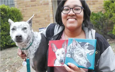  ?? AP Photo/LM Otero ?? ■ Danielle Moore poses for photos with Kana and paintings of the pet Australian cattle dog March 2, 2020, in Dallas.