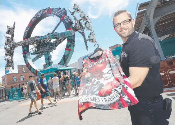  ?? Picture: RICHARD GOSLING ?? Dion Summergree­ne, who is the head of Village Roadshow’s art department, pictured at Movie World with one of his designs.