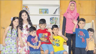  ?? DAVID JALA/CAPE BRETON POST ?? The children of two Syrian refugee families now living in Cape Breton were only too happy to pose for a picture at a recent open house at the Cape Breton Centre for Immigratio­n offices at the New Dawn Centre for Social Innovation (former Holy Angels...