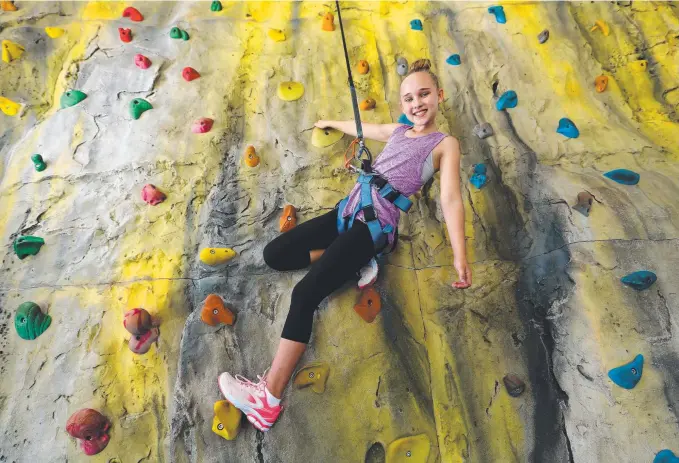  ?? Picture: ADAM HEAD ?? Chloe Ward, 11, of Arundel, tackles the 10m rock face at the Gold Coast Recreation Centre at Palm Beach.