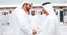  ??  ?? Shaikh Hazza Bin Zayed Al Nahyan, Deputy Chairman ■ of the Abu Dhabi Executive Council, greets Mohammad Abdullah Al Gergawi at the majlis yesterday. WAM