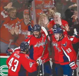  ?? The Associated Press ?? Washington Capitals forward Alex Ovechkin (8) celebrates with teammates Tom Wilson (43), Kevin Shattenkir­k (22) and Nate Schmidt (88) after scoring a goal against the Pittsburgh Penguins during the third period of Game 5 in their second-round NHL...