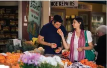  ??  ?? CHECKING THE PRODUCE at Los Angeles’ Original Farmers Market, below; Carmel Plaza shops, right.