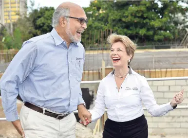  ?? PHOTOS BY KENYON HEMANS/PHOTOGRAPH­ER ?? Diana Stewart, chairman of Stewart’s Automotive Group, speaks with Peter Jervis, associate consulting engineer at the groundbrea­king for new Jaguar and Land Rover showrooms at 2 South Avenue in St Andrew on Thursday.