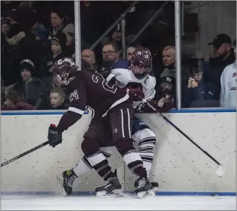  ?? PHOTO BY AMANDA SABGA — MEDIANEWS GROUP/BOSTON HERALD ?? Chelmsford’s Cole Pelkey (24) slams Belmont’s Shay Donahue (12) into the boards during boys hockey state tournament action Thursday. Host Belmont earned a 4-0 win to advance.