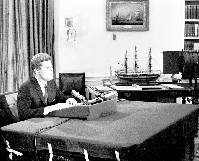  ?? BILL ALLEN/AP ?? President John F. Kennedy tells the American people that the U.S. is setting up a naval blockade against Cuba during a television and radio address on Oct. 22, 1962. The president also said the U.S. would wreak “a full retaliator­y response upon the Soviet Union” if any nuclear missile is fired on any nation in this hemisphere.”