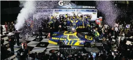  ?? Jared C. Tilton/getty Images ?? The Victory Lane celebratio­n after the 2012 Daytona 500 was a big one for driver Matt Kenseth, team owner Jack Roush and the rest of the crew.