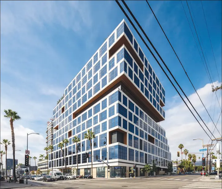  ?? HUNTER KERHART/THE NEW YORK TIMES ?? Solar panels that line the walls and roof of the Epic building in Hollywood, pictured Sunday, help power the building. New technology and stricter standards allow investors to better track a developmen­t’s carbon footprint.