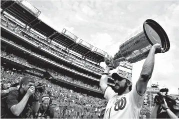  ?? Associated Press ?? ■ Washington Capitals' Alex Ovechkin, from Russia, lifts the Stanley Cup on the field before a baseball game between the Washington Nationals and the San Francisco Giants on Saturday at Nationals Park in Washington.