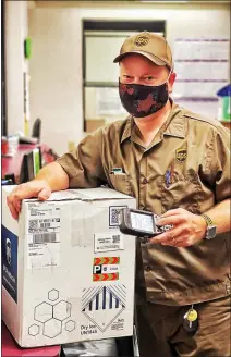  ?? / Robert D. Wilson ?? Courtesy photo
UPS driver Levi Wilson, of Sonora, delivers the first batch of the Pfizer COVID-19 vaccine totuolumne County on Wednesday.