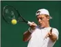  ?? Alastair Grant / Associated Press ?? Tim van Rijthoven returns the ball to Nikoloz Basilashvi­li during the third round at Wimbledon on Friday.