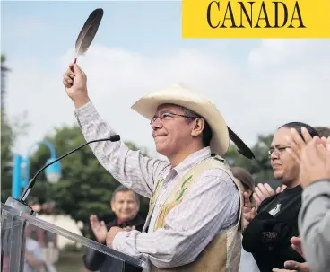  ?? DARRYL DYCK / THE CANADIAN PRESS ?? Coldwater Indian band Chief Lee Spahan raises an eagle feather in Vancouver after responding to a Federal Court of Appeal ruling Thursday that stalled the Trans Mountain Pipeline expansion.