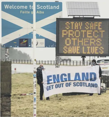  ??  ?? 0 An official sign on the border welcomes people to Scotland, as an unofficial one strikes a rather different tone