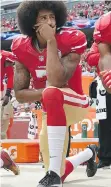  ?? THEARON W. HENDERSON/GETTY IMAGES ?? Colin Kaepernick kneels during the playing of the U.S. anthem in 2016, sparking a long backlash.