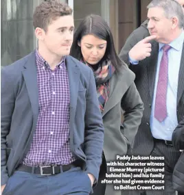  ??  ?? Paddy Jackson leaves with his character witnessEim­ear Murray (pictured behind him) and his family after she had given evidenceto Belfast Crown Court