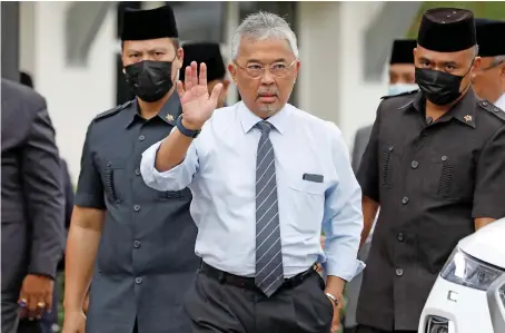  ?? AFP ?? Malaysian King Sultan Abdullah Sultan Ahmad Shah waves to media members waiting outside the National Palace in Kuala Lumpur, Malaysia, on Tuesday.