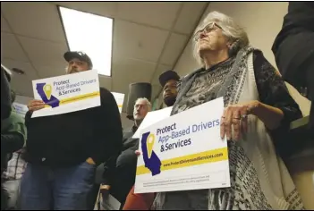  ?? ASSOCIATED PRESS FILES ?? Carla Shrive (right), who drives for various gig companies, joined other drivers last year in Sacramento to support a proposed ballot initiative challengin­g a recently signed law that makes it harder for companies to label workers as independen­t contractor­s.