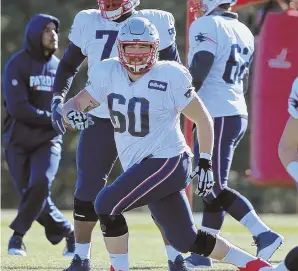  ?? STAFF PHOTO BY JOHN WILCOX ?? HE’S BACK: Center David Andrews gets loose at the start of yesterday’s Patriots practice in Foxboro.