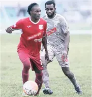  ??  ?? UWI FC’s Fabion McCarthy (right) tracks Boys’ Town FC’s Andrew Peddlar during their Red Stripe Premier League match at the UWI Mona Bowl on October 8.