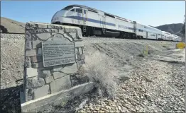  ?? Dan Watson/For The Signal ?? A Metrolink train passes by the historical marker for Lang Station in Canyon Country.