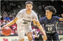  ?? JAVIER GALLEGOS/THE NEW MEXICAN ?? Volcano Vista’s Kenyon Aguino, left, dribbles toward the basket while being guarded by Artisco Heritage’s Latavious Morris on Wednesday during a 5A quarterfin­al in The Pit.