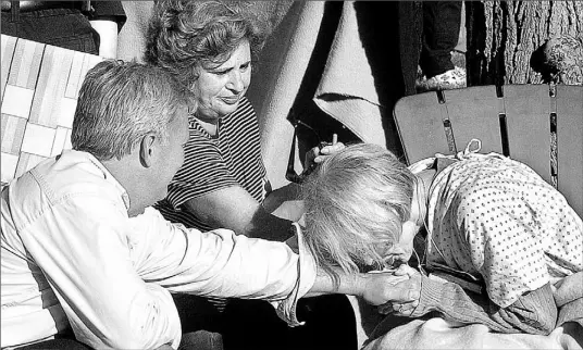  ?? T.J. HOOKER/THE POST-STAR/ AP ?? Rescuer Brian Hart, left, of East Greenbush, N. Y., is thanked by one of the women he saved from drowning in the boating tragedy yesterday afternoon on Lake George. It’s not yet known what caused the Ethan Allen to capsize in calm waters.