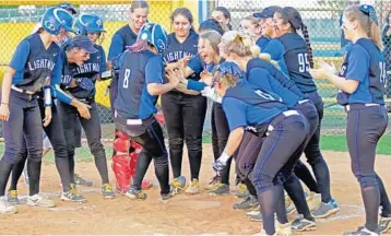  ?? JOHN MCCALL/STAFF PHOTOGRAPH­ER ?? Maegan Osmond of Cypress Bay celebrates with teammates at home plate after hitting a home run against Monarch during the 9A softball regional quarterfin­al in Weston on Wednesday.