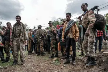  ?? — AFP photo ?? Members of the Amhara militia gather in the village of Adi Arkay, 180 kilometres northeast from the city of Gondar, Ethiopia.