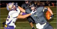  ?? Special to the Democrat-Gazette/MARK STALLINGS ?? Charleston’s Dylan Jones (8) fends off a tackle by Booneville’s Josh Smith in the Tigers’ 21-14 victory Friday, putting them in the Class 3A state championsh­ip game against Smackover.