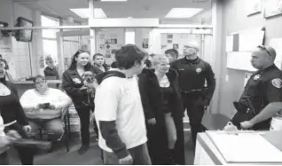  ??  ?? Cheryl Pitchford, third from right, the mother of a 14-year-old Reno boy who was shot last week by a campus police officer, waits for school officials to accept a petition on non-lethal force in the lobby of the Washoe County School District...