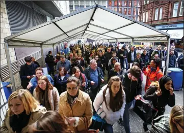  ??  ?? Going nowhere fast: Commuters queuing amid lengthy delays at Queen Street station