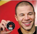  ??  ?? Flames’ Jarome Iginla holds the puck he used to score his 500th career NHL goal against the Minnesota Wild in Calgary in 2012.
Iginla has been named to the Hockey Hall of Fame.