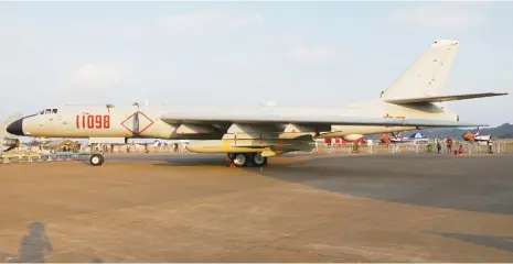  ?? Photos: IC ?? China’s H-6K bombers A Chinese military officer with a Chinese People’s Liberation Army (PLA) Air Force flag disembarks from a Chinese military aircraft.