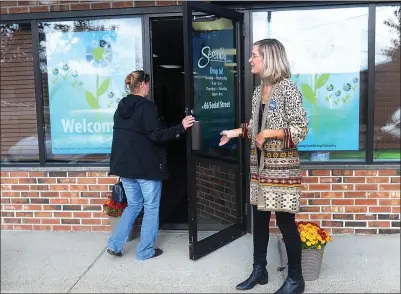  ?? Ernest A. Brown photo ?? Christa Thomas-Sowers, right, welcomes clients to the new Serenity Center located at 66 Social St. in Woonsocket during the center’s open house Tuesday morning.