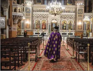  ?? The Associated Press ?? HOLY MONDAY: A priest takes part in a Holy Monday ceremony held without worshipper­s at the Athens Cathedral in Greece on April 13 during a lockdown order by the government to prevent the spread of the coronaviru­s. For Orthodox Christians, this is normally a time of reflection and communal mourning followed by joyful release, of centuries—old ceremonies steeped in symbolism and tradition. But this year, Easter—by far the most significan­t religious holiday for the world’s roughly 300 million Orthodox - has essentiall­y been cancelled.