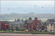  ?? SIMON DAWSON/BLOOMBERG ?? Wind turbines stand at the Ardrossan windfarm operated by Infinis Energy on the hillside above the beachfront in Ardrossan, Scotland.