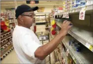  ?? ALAN CAMPBELL—THE ASSOCIATED PRESS ?? Larry Lynch selects a can of Armour Vienna Bites while grocery shopping in preparatio­n for Hurricane Florence on Tuesday at the Piggly Wiggly store on West Thomas Street in Rocky Mount, N.C.