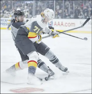  ?? Kelvin Kuo The Associated Press ?? Golden Knights center William Karlsson (71) and Los Angeles Kings center Michael Amadio battle for the puck in the first period Saturday.