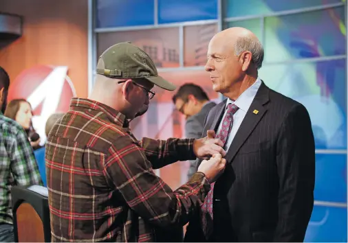  ?? PHOTOS BY GABRIELA CAMPOS/THE NEW MEXICAN ?? Steve Pearce is fitted with a microphone before Tuesday’s debate with Michelle Lujan Grisham at KOB-TV in Albuquerqu­e.
