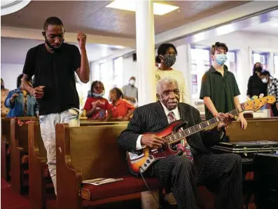  ?? Photos by Matthew Busch / Contributo­r ?? Charles Hamilton, 80, plays a bass guitar during a celebratio­n of the 150th anniversar­y of New Light Baptist Church. More than 50 parishione­rs took part in the celebratio­n that included a procession and worship service.