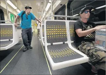  ?? Photograph­s by Mel Melcon Los Angeles Times ?? MATT HARRISON sits on a vinyl seat in a subway car on Metro’s Red Line. The new vinyl seats have a drainage hole to prevent liquids from pooling — a much-hated problem with the old fabric seats.
