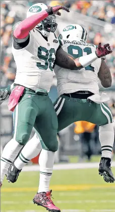  ??  ?? YES! Sheldon Richardson (right) and Muhammad Wilkerson celebrate after sacking Kirk Cousins.