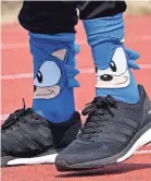  ??  ?? Noah Lyles has sported socks featuring Sonic the Hedgehog, above, Power Rangers and The Incredible­s.