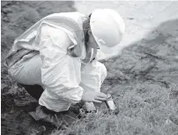  ?? STAFF FILE PHOTO ?? A worker tests the soil for lead as contractor­s scrape up topsoil from the backyard of The Church on Main in October 2012.