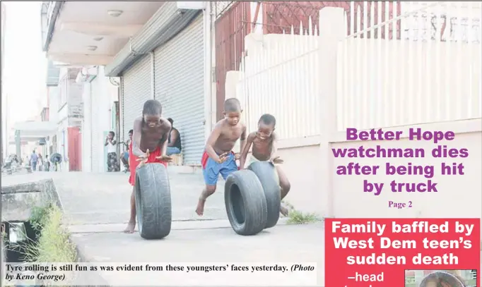  ?? By Keno George) (Photo ?? Tyre rolling is still fun as was evident from these youngsters’ faces yesterday.