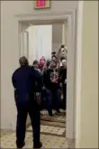  ?? HuffPost via AP ?? In this video still, Officer Goodman holds off an angry mob Jan. 6, 2021, inside the Capitol.