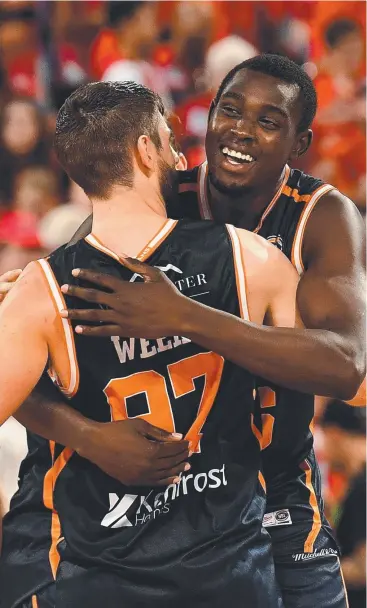  ?? Picture: GETTY IMAGES ?? SWEET VICTORY: Kuany Kuany and Jarrad Weeks of the Taipans celebrate after their win over the Wildcats at Perth Arena on Friday.